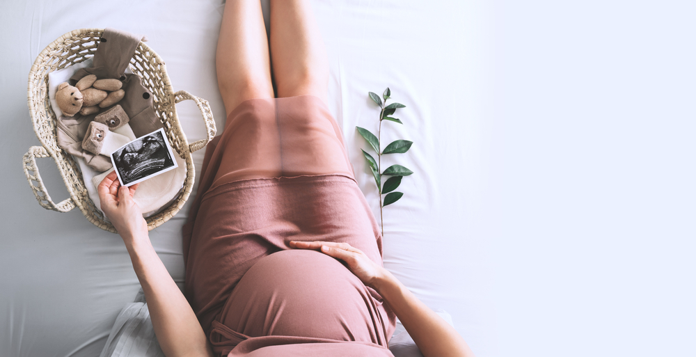 Maternity photo of woman holding an ultrasound